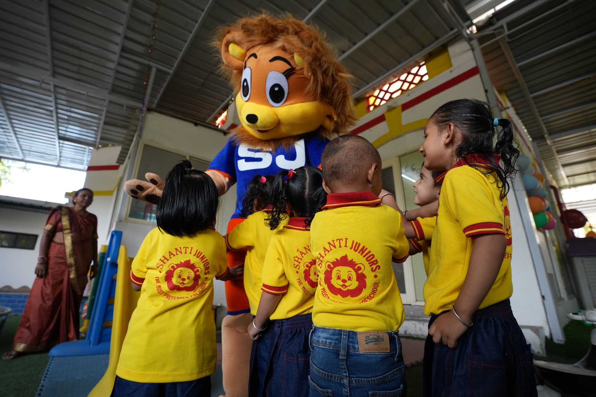 Sheon mascot with Shanti Juniors students